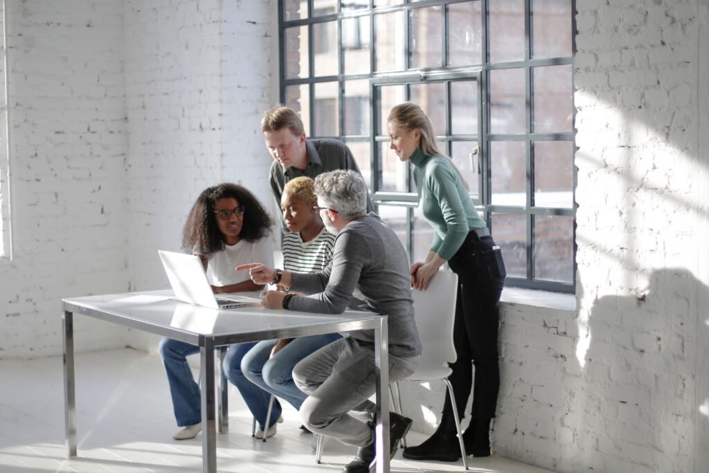 Diverse professionals collaborating on a laptop, illustrating the UNICEF Internship Programme 2027 for students and recent graduates.