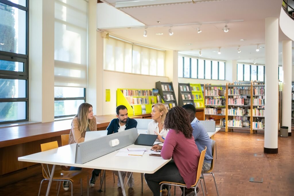 International students studying together in a university library, illustrating the University of Southern Denmark Scholarships 2027.